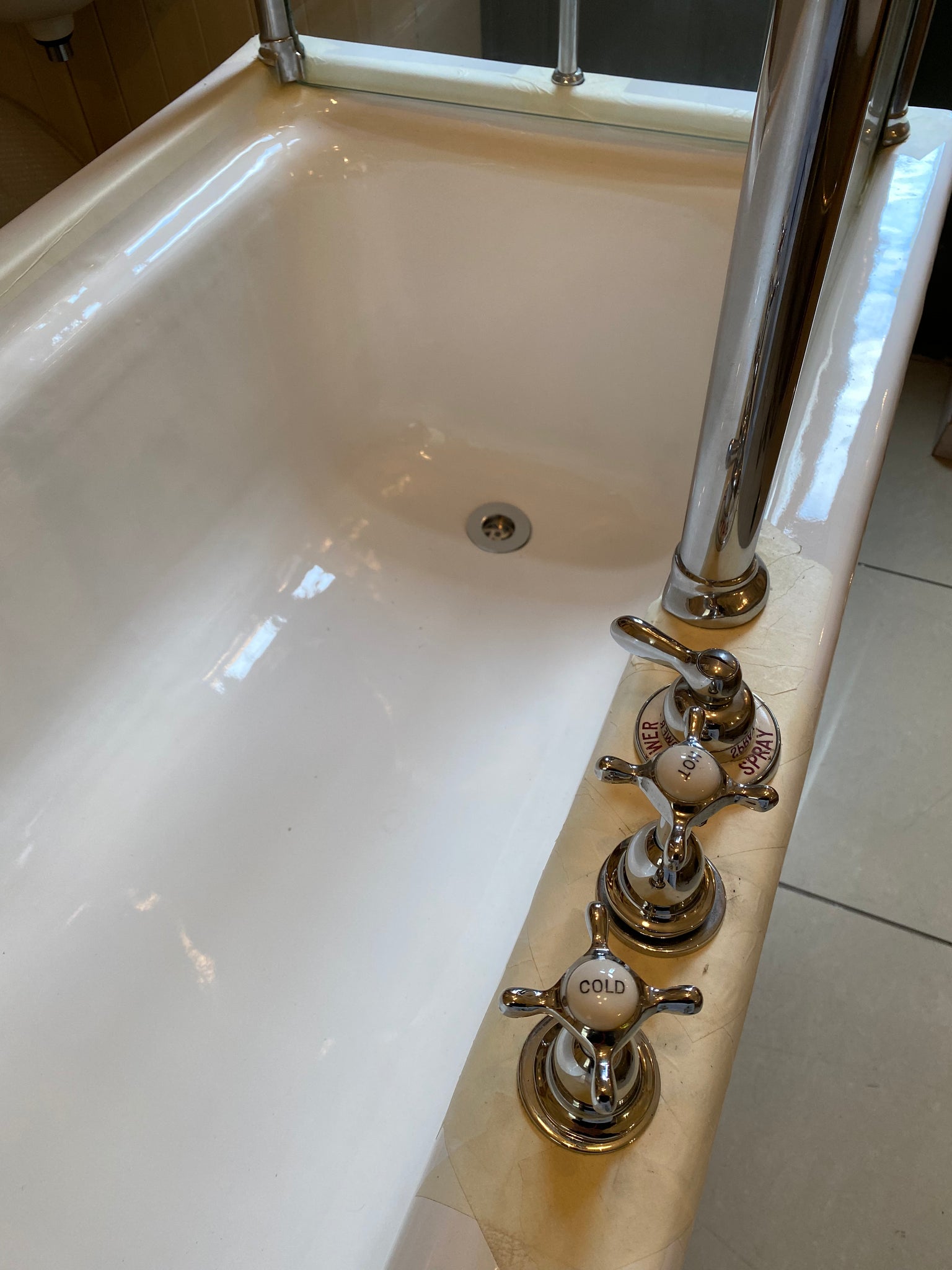 1930's cast iron shower bath with glass screens and chrome plated brassware